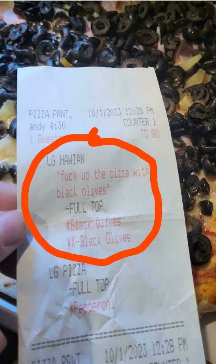 Pizza with extra black olives, receipt showing food service worker's compliance with request.