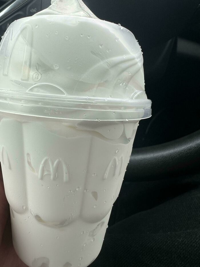 Overflowing ice cream in a McDonald's cup, showing extra portion compliance by food service workers.