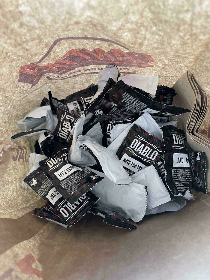 Bag filled with extra Diablo sauce packets from a food service worker's generous compliance with a customer's request.