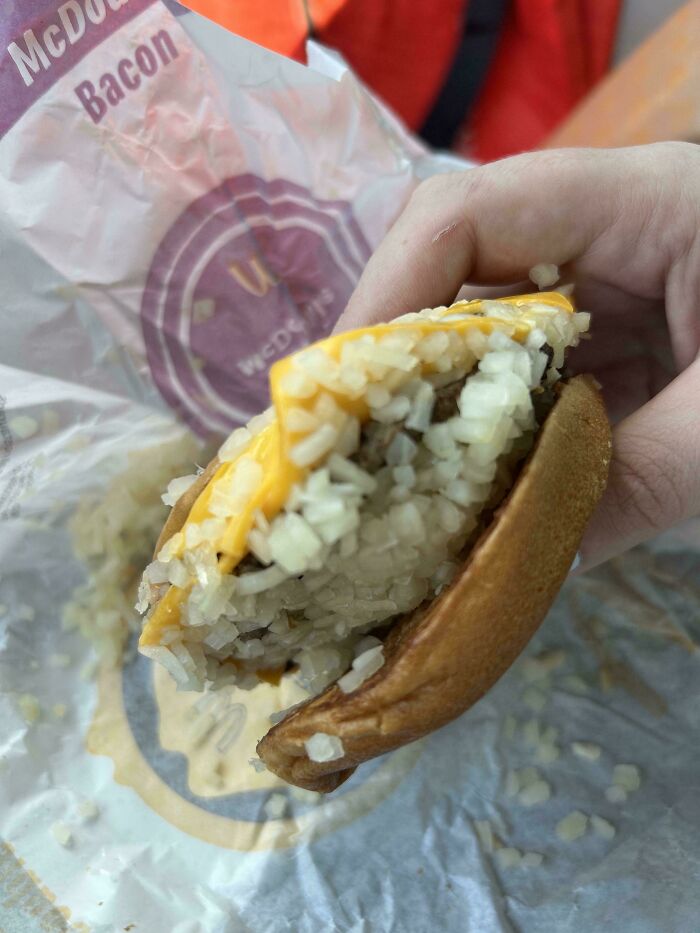 Burger with extra onions, showing food service workers' delightful compliance with customer requests.