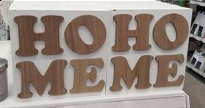 Sign fail with wooden blocks spelling "HO HO ME" on display.