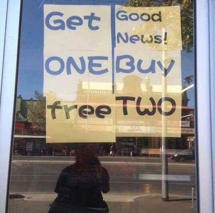 Sign fail with view of street, text unevenly arranged as "Get Good News! ONE Buy free TWO."