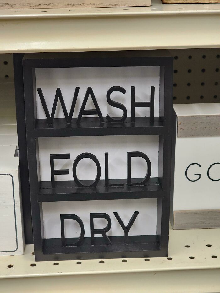 Sign reading "Wash Fold Dry" out of order on a store shelf, illustrating a classic "You Had One Job" fail.