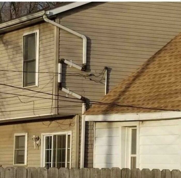 Pipes installed incorrectly on house exterior, a classic “you had one job” fail.