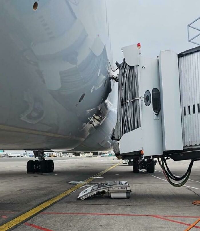 Airplane gate boarding fails with damage to the aircraft, showing a mishap that highlights "you had one job" scenario.