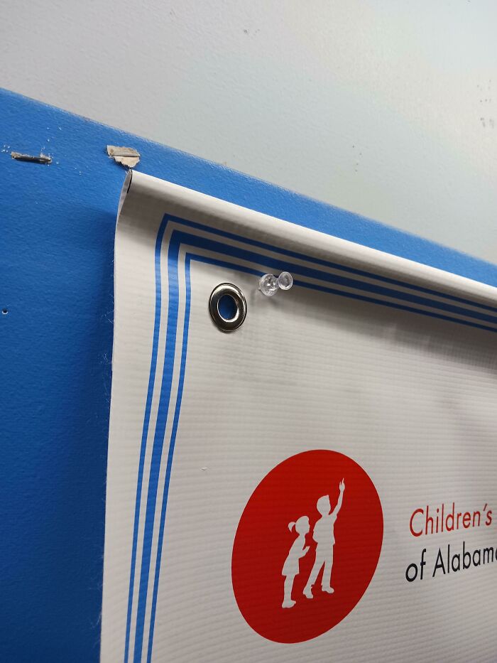 Banner fail with pin used beside grommet, featuring Children’s of Alabama logo.