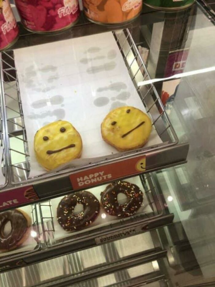 Donuts with crooked smiley faces on display, highlighting a funny fail moment.