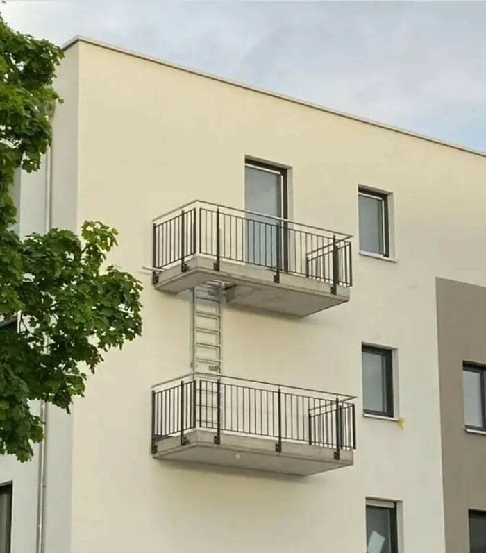 Two balconies connected by a ladder, showcasing a hilarious architectural fail.