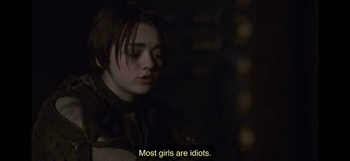 Young woman in dim light wearing medieval attire, illustrating male authors' misunderstanding of women in popular media.