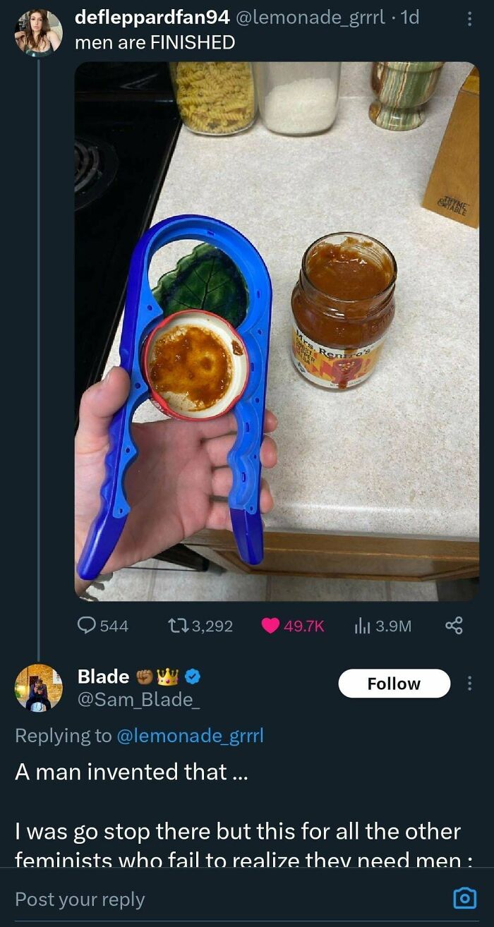 Hand holding blue plastic jar opener with peanut butter jar on countertop, highlighting a reality check on misogynists.