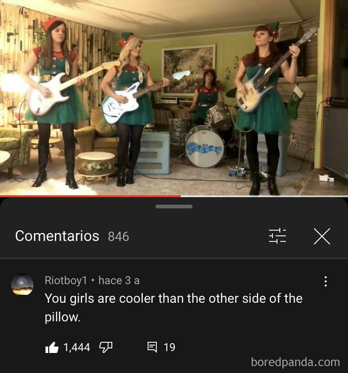 Band performing in a room with Christmas outfits, with a comment saying, "You girls are cooler than the other side of the pillow."