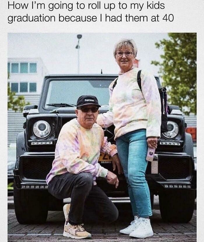 Two adults in colorful sweatshirts posing humorously in front of a car, showcasing funny and goofy dad moments.