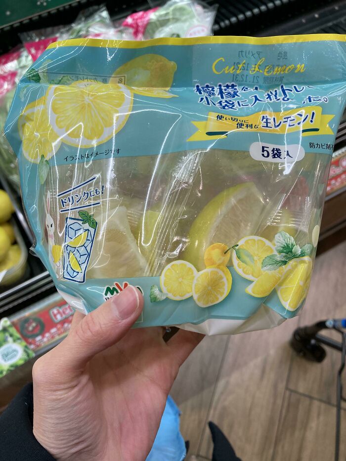 Hand holding poorly designed lemon packaging with misleading graphics.