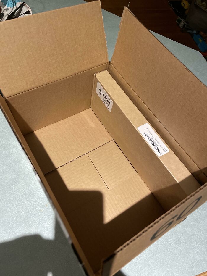 Oversized product packaging with a small box inside, illustrating excessive packaging practices.