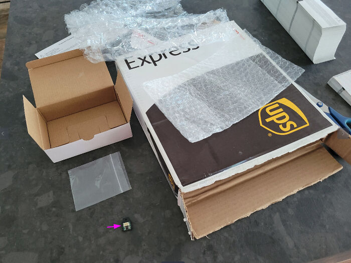 Excessive packaging: small item in large UPS box with bubble wrap, highlighting inefficient product packaging.