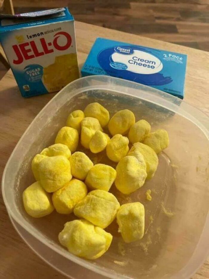 Yellow Jell-O and cream cheese balls in a container, showcasing one of the unbelievable dishes.