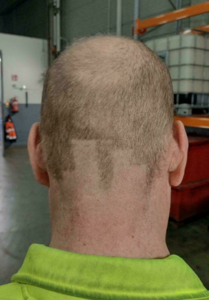 Back of a man’s head showing a poorly executed DIY haircut disaster with uneven patches of hair missing.