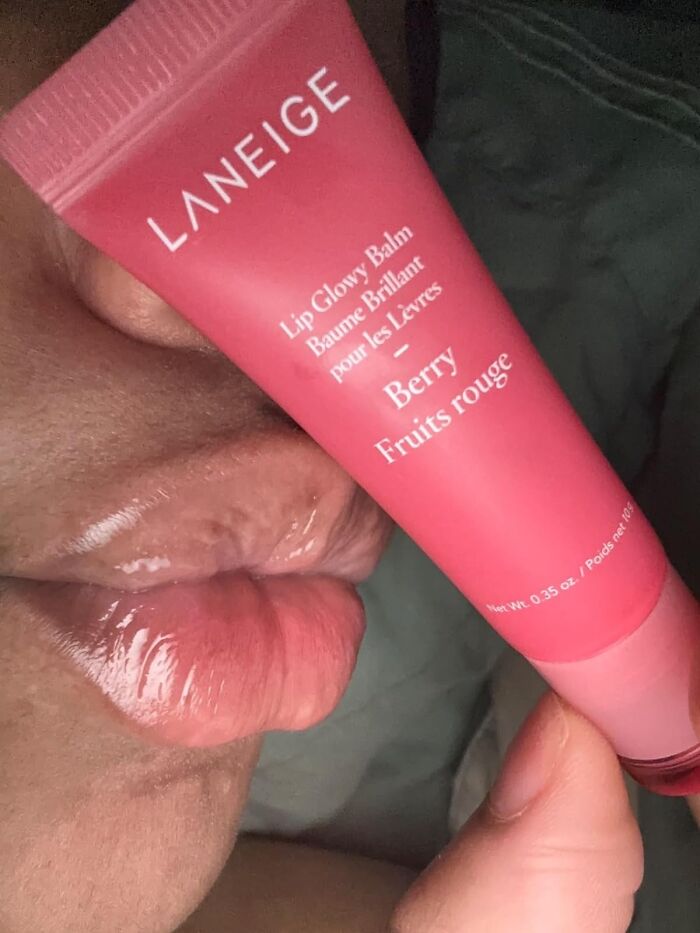 Close-up of glossy lips applying Laneige Berry Lip Glowy Balm, a cheerful Mother's Day gift under $20.