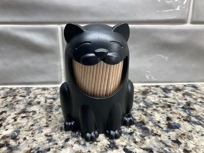 Black cat toothpick holder on a kitchen counter, part of this year's awesome shopping list.