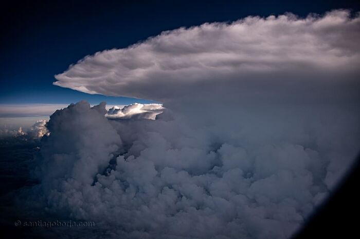 Aerial photo showing dramatic cloud formations with a deep blue sky captured by a pilot in breathtaking detail.