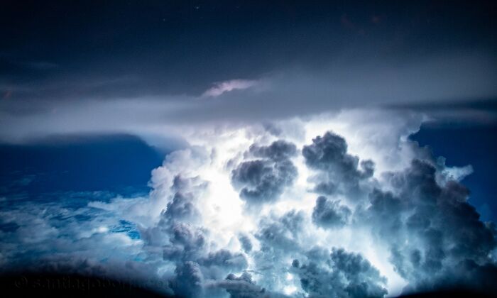 Dramatic aerial photo showing illuminated storm clouds captured by a pilot during a captivating sky flight.