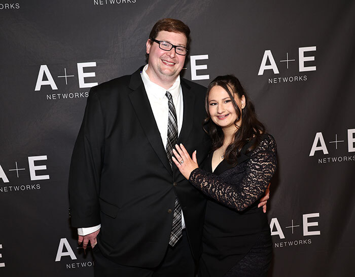 A couple poses at an A+E Networks event.
