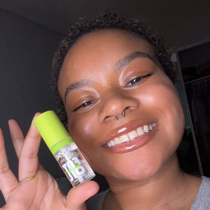 Smiling person holding a small bottle, ideal as a cheap Mother’s Day gift under $20.