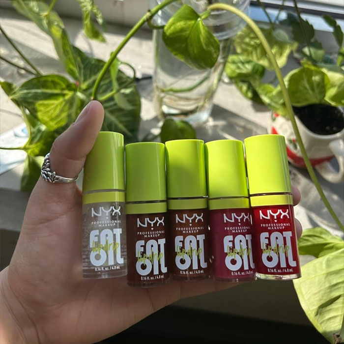 Smiling person holding a small bottle, ideal as a cheap Mother’s Day gift under $20.