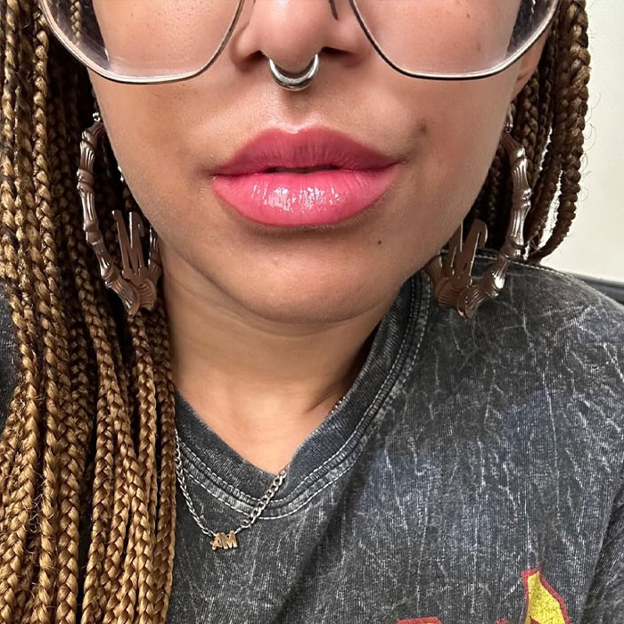 Smiling person holding a small bottle, ideal as a cheap Mother’s Day gift under $20.