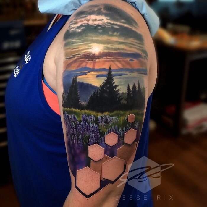 Stunning landscape tattoo with a forest and hexagonal designs by a creative artist.