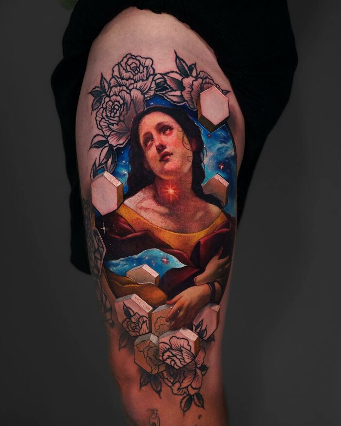 Tattoo depicting a woman surrounded by flowers and geometric shapes, capturing a world within the skin.