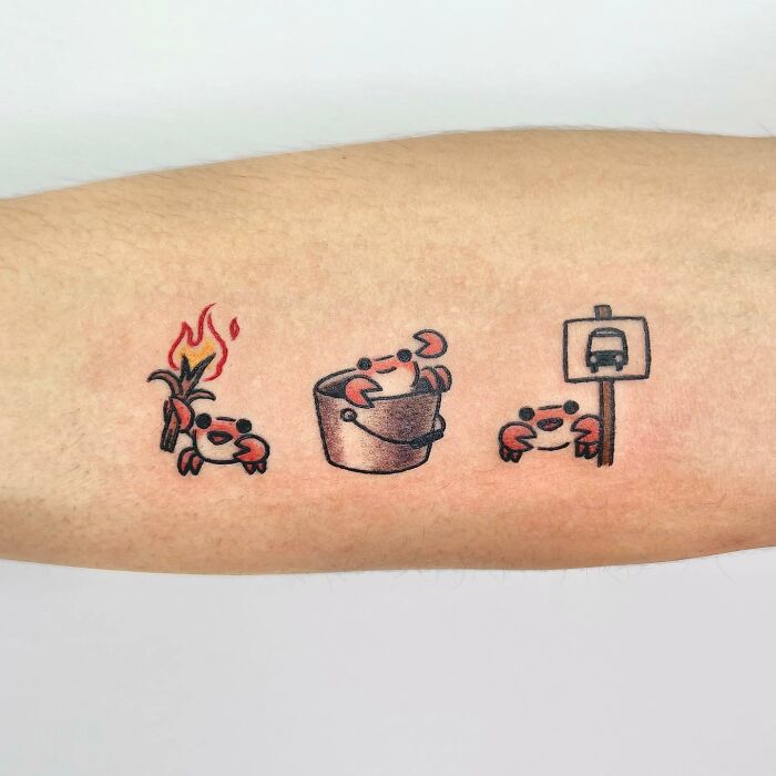 Charming tattoo of playful crabs by Buoy, featuring a sequence of activities including fire and waiting by a bus stop sign.