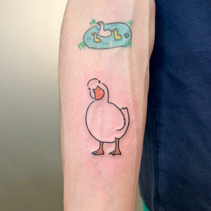 Charming tattoo by Buoy featuring a white cartoon duck on an arm.