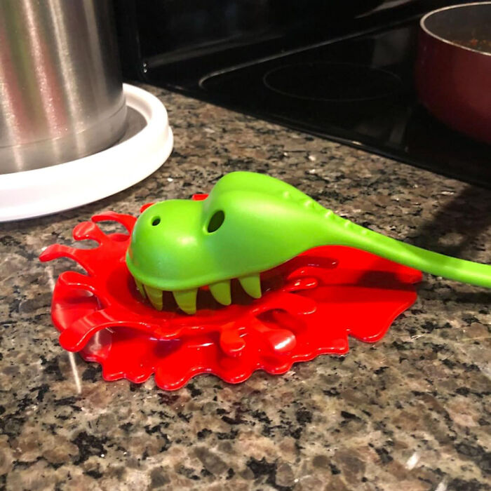 Dinosaur-shaped kitchen item with splash design on granite countertop.