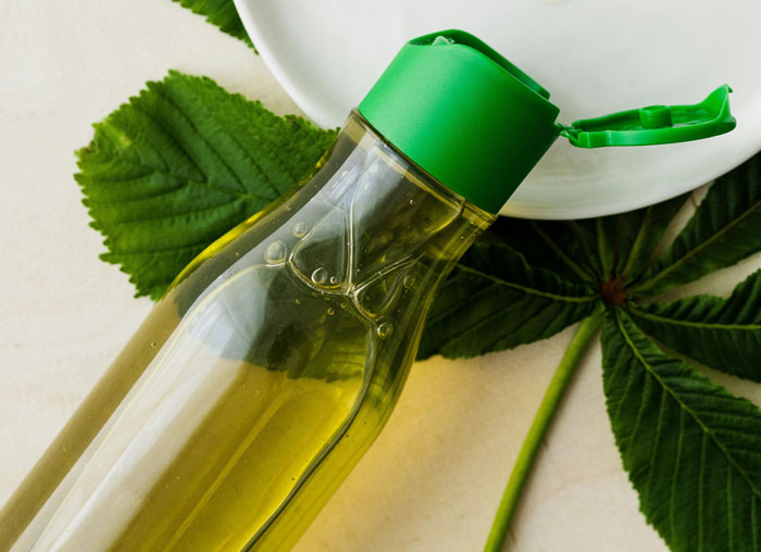 Bottle of natural dog teeth cleaner with herbal leaves, an alternative to brushing.