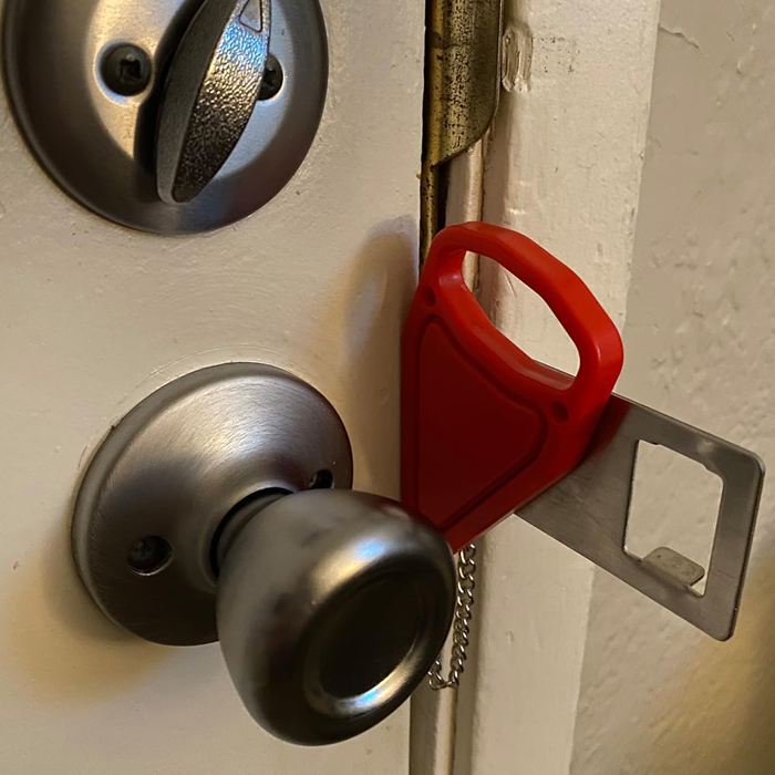 Portable travel lock on a door k**b, providing extra security for smart and light travel.