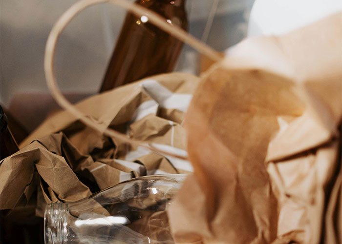 Crinkled brown paper and glass jars scattered closely, illustrating shocking living conditions people have witnessed.