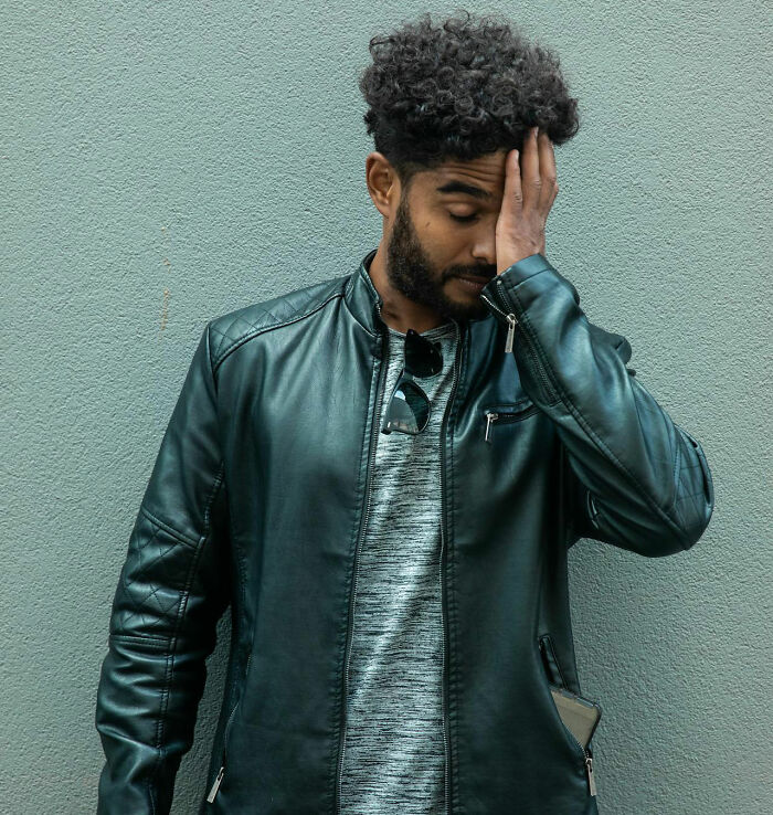 Man in a leather jacket looking frustrated, capturing the idea of unfortunate names given to babies. - 23