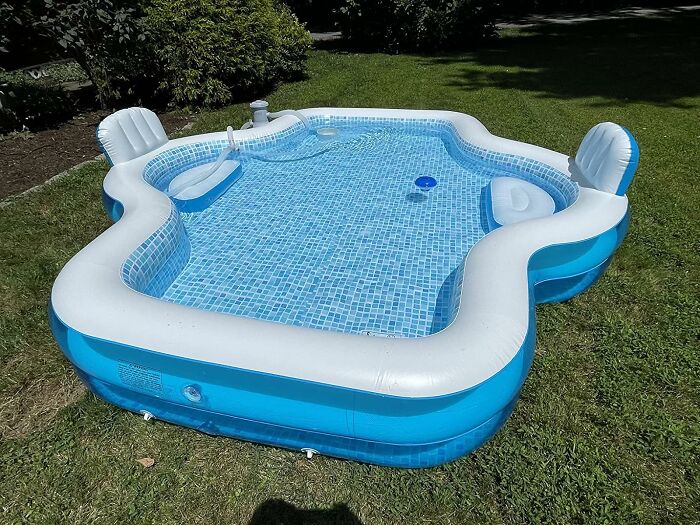 Inflatable garden pool set up on green lawn, ideal for low-effort garden finds and easy backyard relaxation.