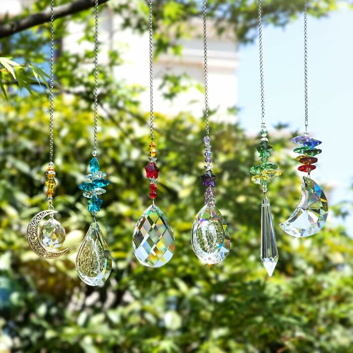 Colorful crystal suncatchers hanging outdoors, adding charming outdoor upgrades to enhance your backyard this summer.