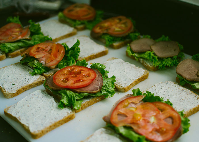 Open sandwiches with lettuce, tomato, and meat on bread, illustrating unfiltered food opinions and crunchy textures.
