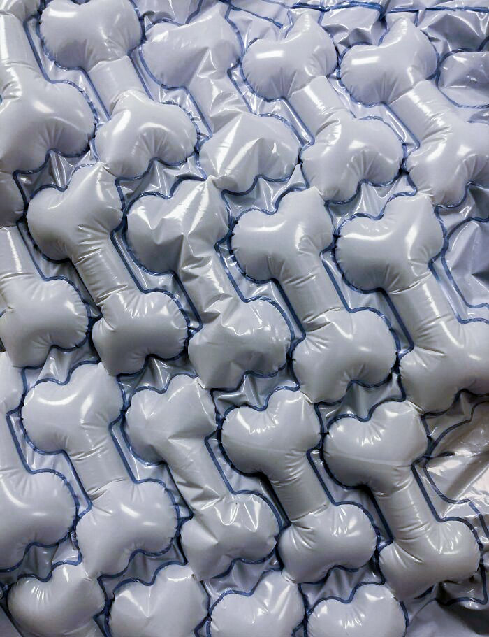 Inflatable bone-shaped packaging bubbles, stacked neatly, creating a playful pattern at the veterinarian's office.