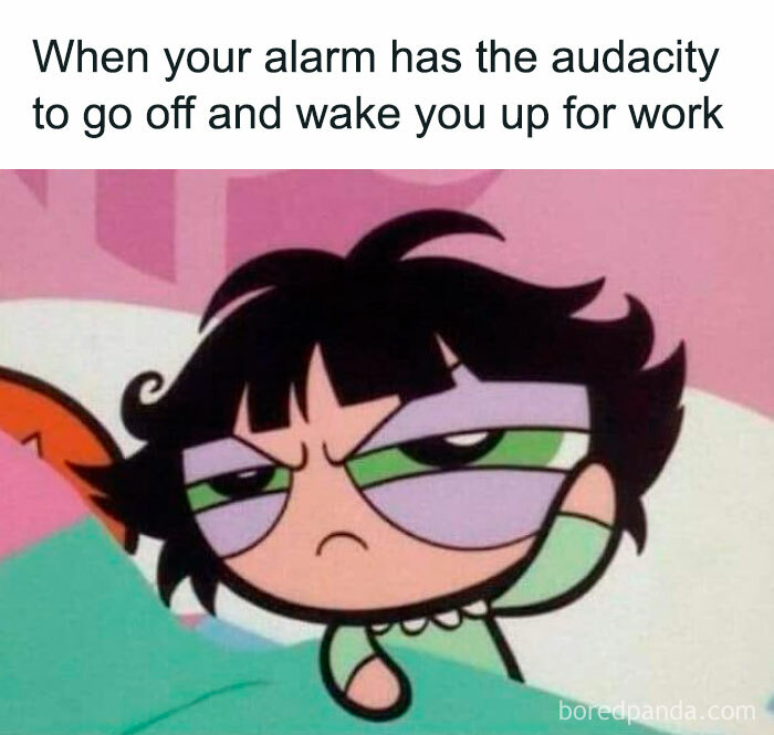 Cartoon character looking grumpy in bed, with a funny work meme caption about waking up.