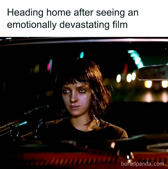 Woman with tired expression driving at night, a funny movie meme capturing emotions after watching a devastating film.