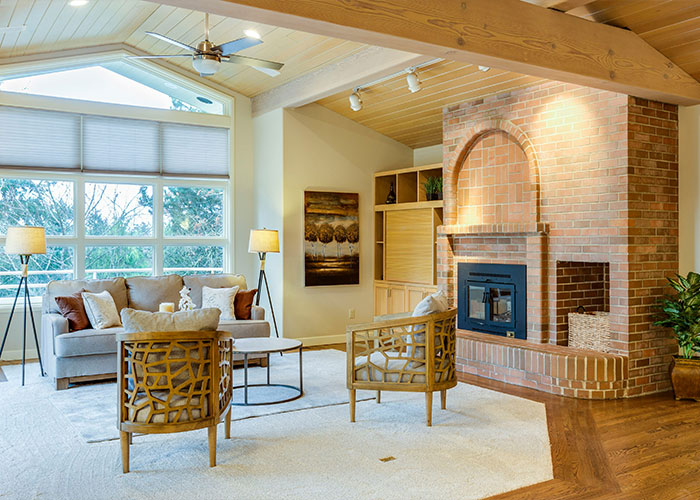 Bright living room with modern furniture and brick fireplace, illustrating strange childhood realities far from normal.