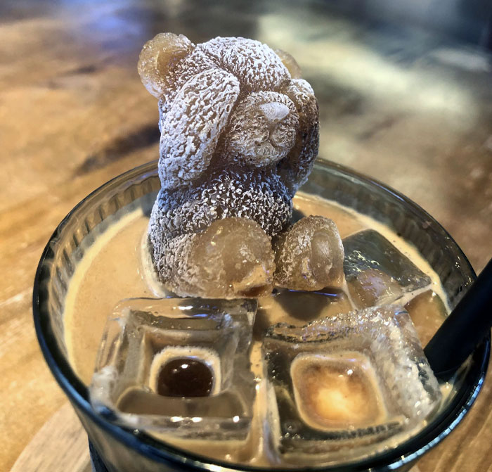 Creative bar drink featuring a teddy bear shaped ice cube and unique ice cubes, showcasing brilliant bar ideas.