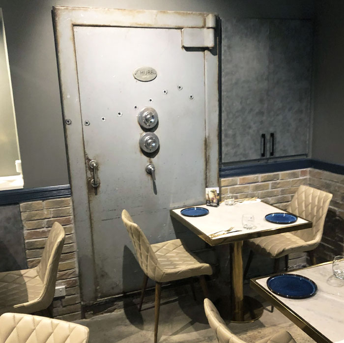 This Restaurant Has What Seems To Be An Old Vault In The Wall With Bullet Holes In It