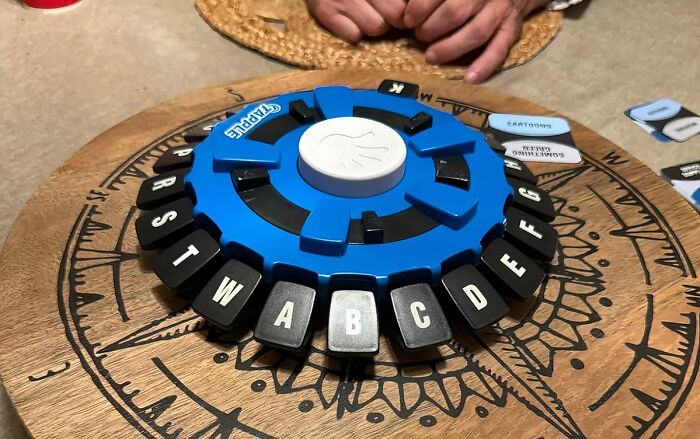 Board game with letter tiles on a round wooden table, perfect for a cheerful Mother’s Day gift under $20.