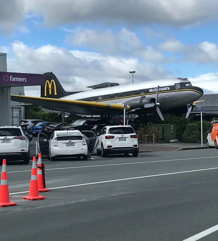 Vintage airplane converted into a McDonald's restaurant with cars parked outside, showcasing brilliant bar and restaurant ideas.