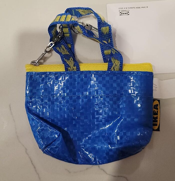 Small blue and yellow IKEA bag with keychain attachment, showcasing genius and borderline random design elements.